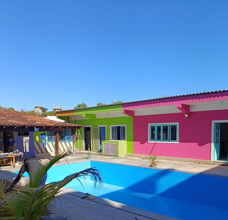 a house with a swimming pool in front of it at Pousada das Ostras in Anchieta