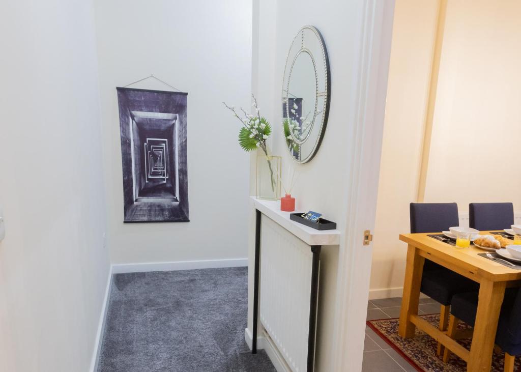 a room with a table and a mirror on the wall at Stay at Waltz Gate in Horley