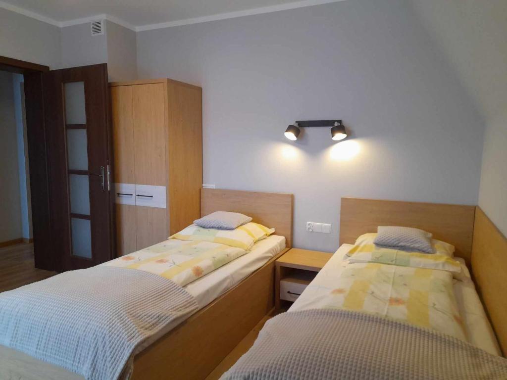 Posteľ alebo postele v izbe v ubytovaní Pokoje Gościnne Budzowie