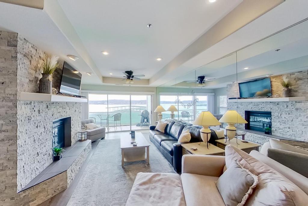 a living room with a couch and a fireplace at Waters Edge in Lake Ozark