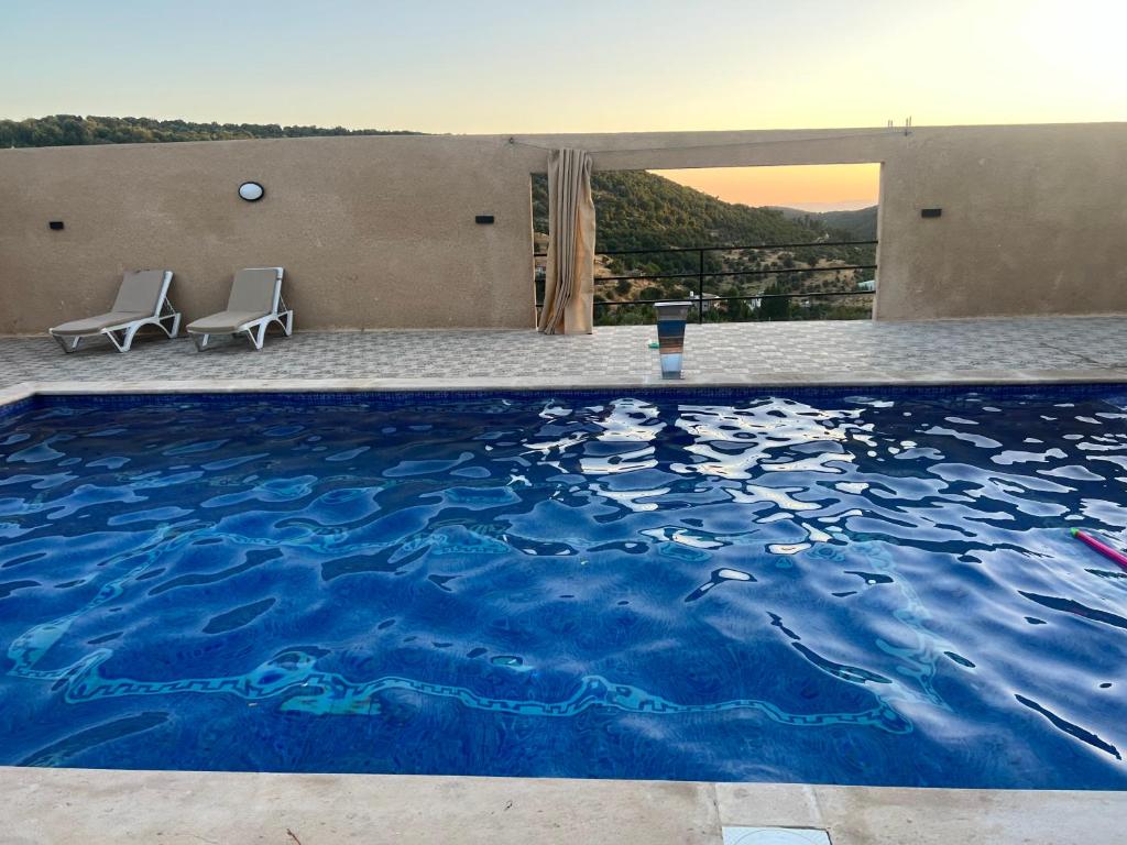 a large swimming pool with a painting on it at Gernath farm in Ajloun