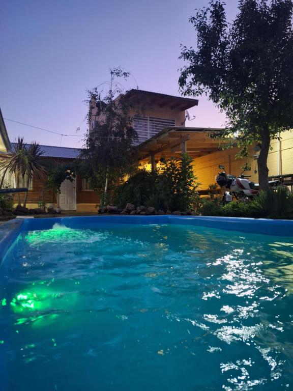 a swimming pool in front of a house at La Chacrita in Plottier