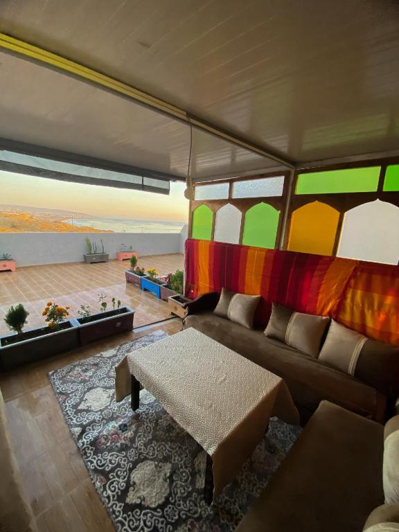 a living room with a couch and a table at taghazout life Guest House in Taghazout