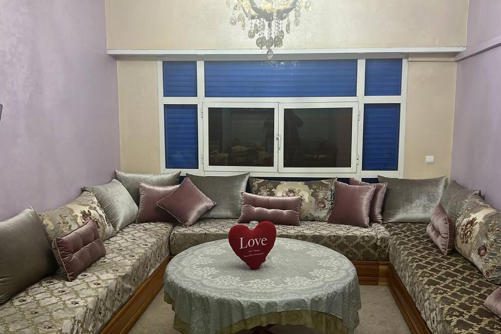 a living room with a couch with a heart on it at Agadir Morocco Furnished apartment for long-term rental in Agadir