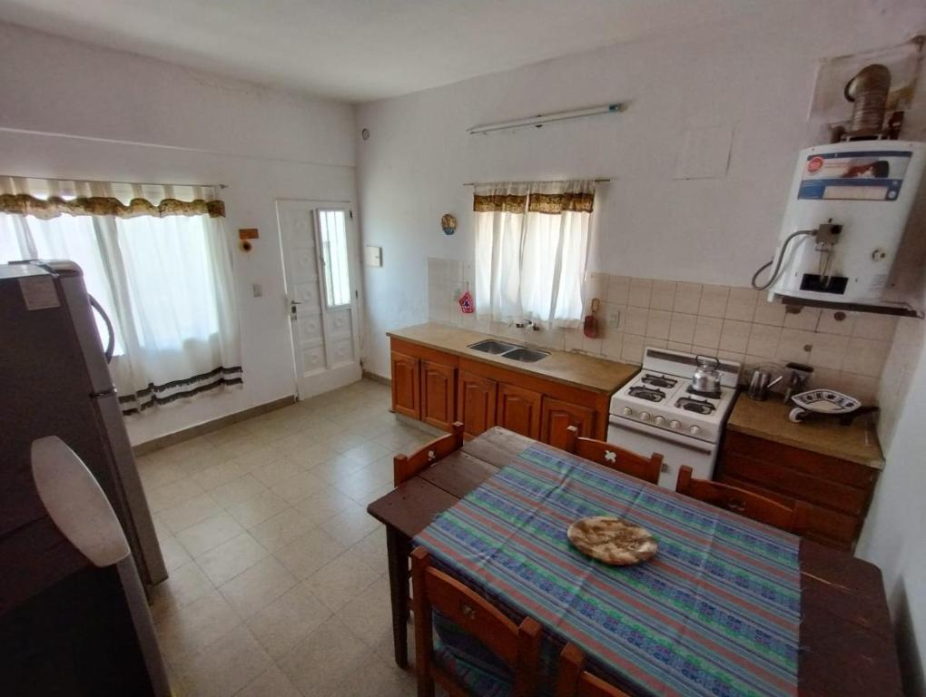 a kitchen with a table and a stove at Casita Festiva in Santa María