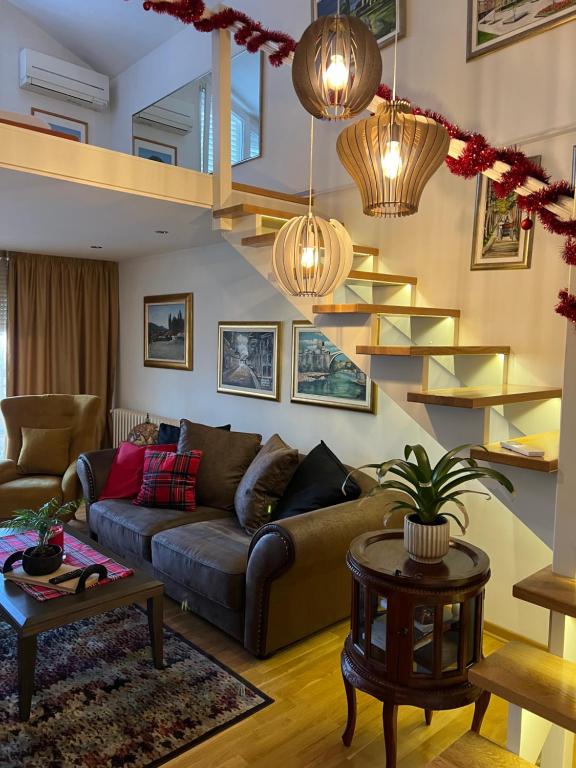 a living room with a couch and some shelves at Apartment ON TOP 23 in Belgrade