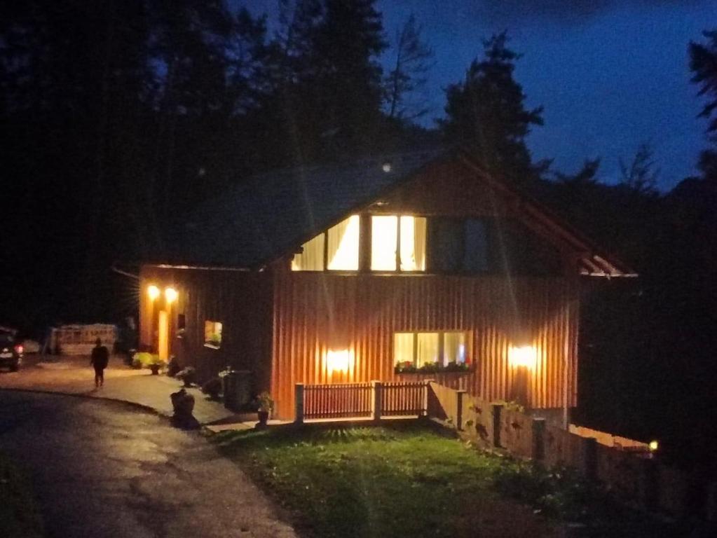 a house with lights on the side of it at night at Apartment A&A in Niederdorf