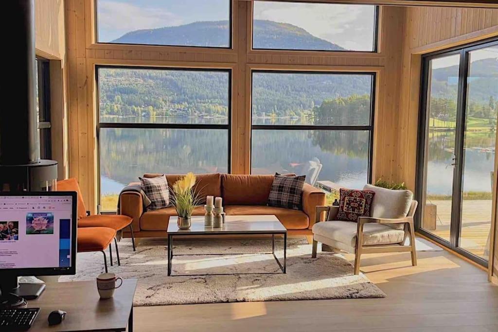 a living room with a couch and a table at Lakefront Villa, exclusive leisure property near Vrådal Golf, Straand Summerland & Panorama Ski center in Vradal