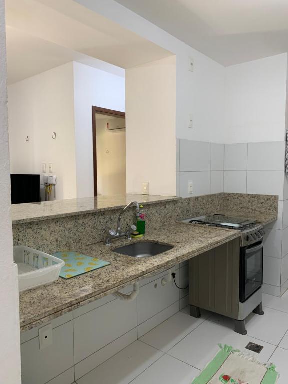 a kitchen with a sink and a counter top at Flat Barra do Cunhaú in Canguaretama