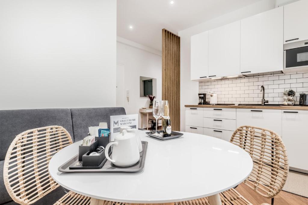 a white table and chairs in a kitchen at Sweethome Marconi in Rome