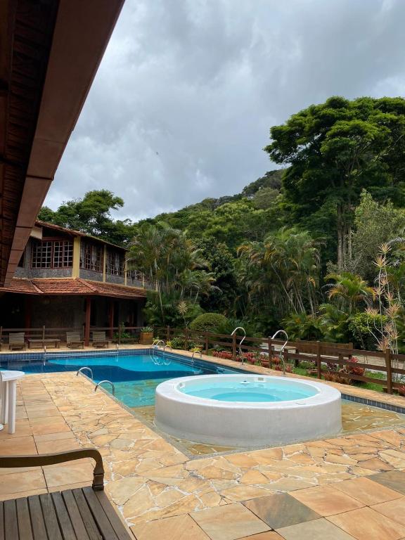a swimming pool in front of a resort at VILLA MIA DUO in Itaipava