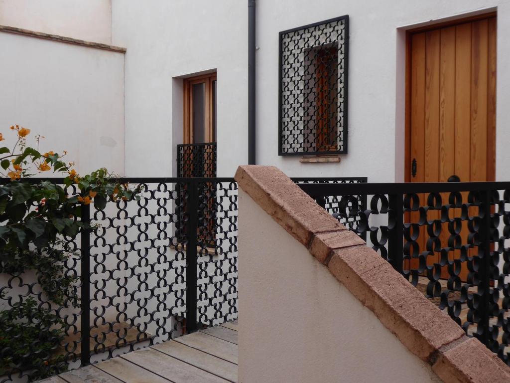 a house with a black and white fence at Casa de la escalera 1ª D in Córdoba