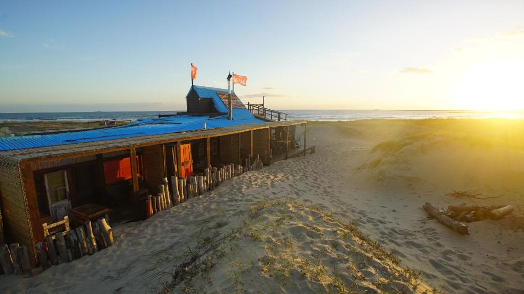 a building on the beach next to the ocean at Narakan Cabo Polonio in Cabo Polonio