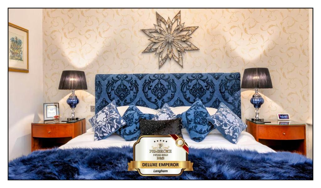 a bed with blue pillows and a star on the wall at Pembroke Bed & Breakfast in Blackpool