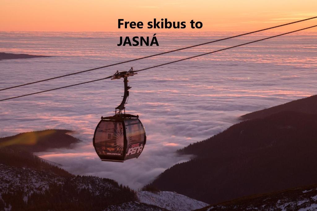 a cable car is flying over the clouds at Tatralandia Apartmán in Liptovský Mikuláš