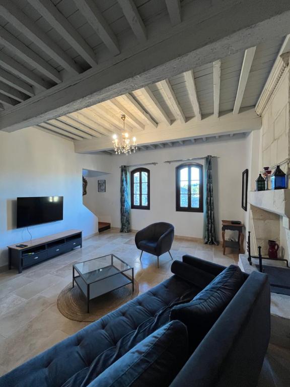 a living room with a couch and a tv at La Maison de Pierrette in Les Baux-de-Provence