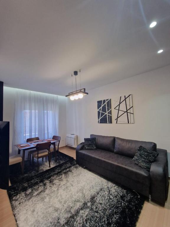 a living room with a couch and a table at YourHome in Korçë
