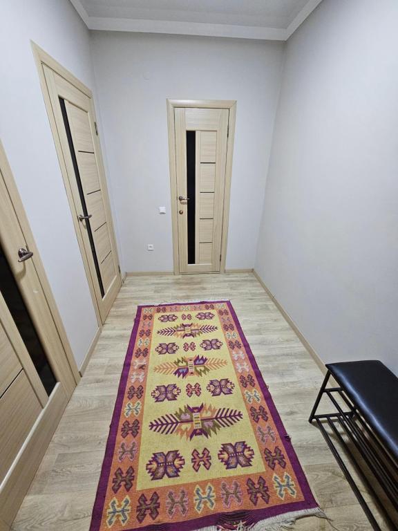 an empty room with a rug on the floor at 2 комнатная квартира in Aktobe