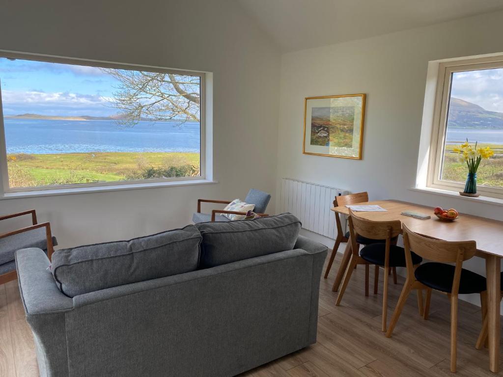 a living room with a couch and a table at Curlew Cottage 