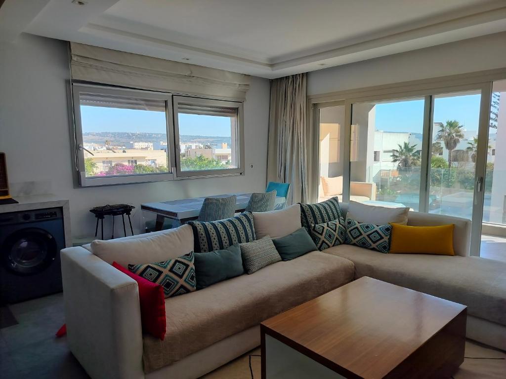 a living room with a couch and a table at Appartement haut standing in Essaouira