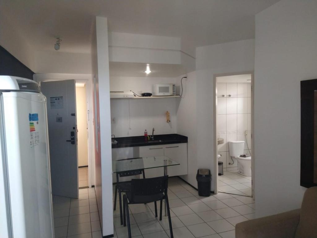 - une cuisine avec une table et des chaises dans la chambre dans l'établissement Apartamento Biarritz, à São Luís