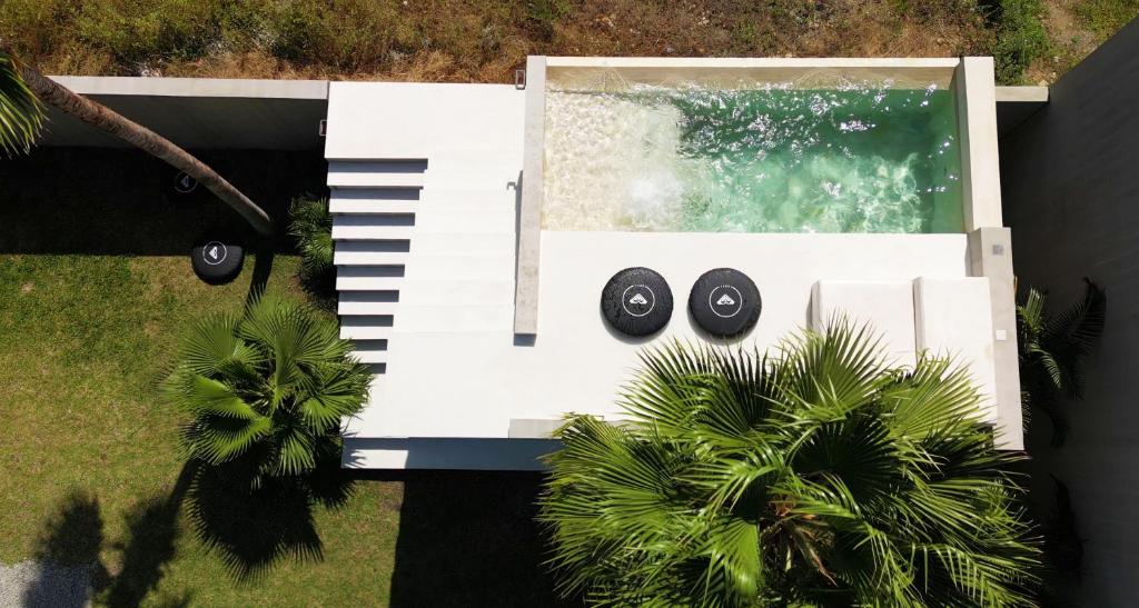 an overhead view of a white piano with black wheels at Casa SANA in Puerto Escondido