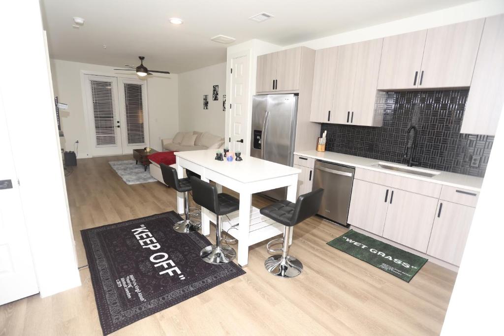 a kitchen with a white table and a refrigerator at Heights Hacienda Hideaway in Houston