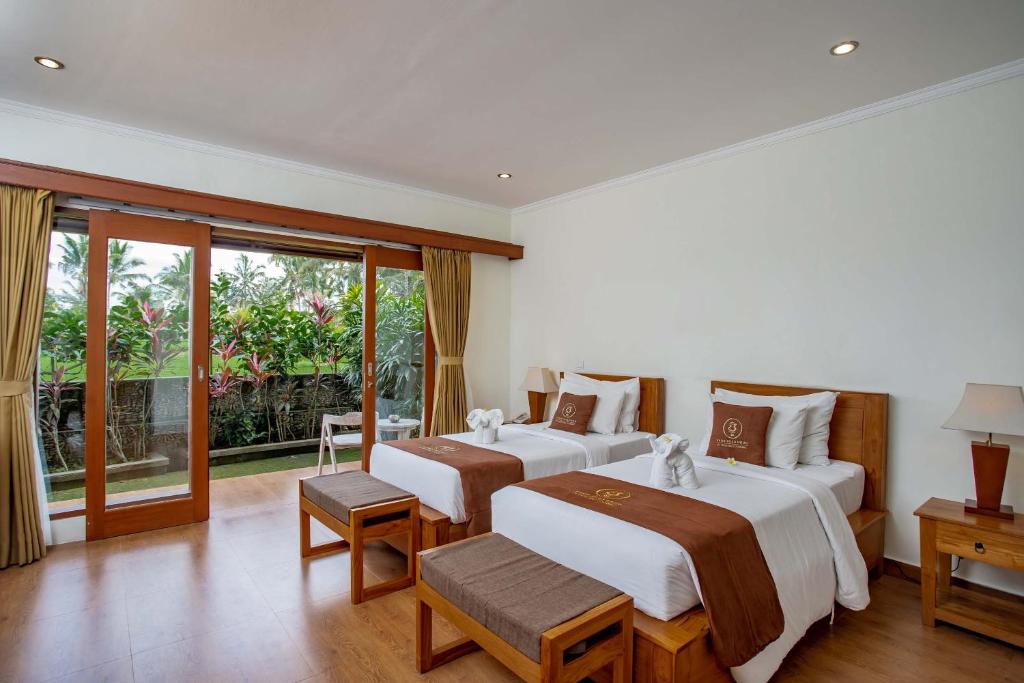 Postel nebo postele na pokoji v ubytování Paon Desa Ubud