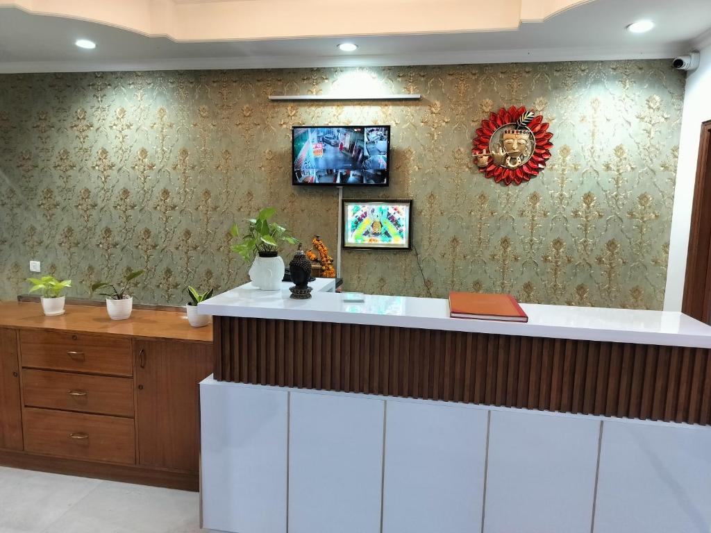 a kitchen with a white counter and a wall at Hotel Soft Petal Residency - Delhi Airport in New Delhi