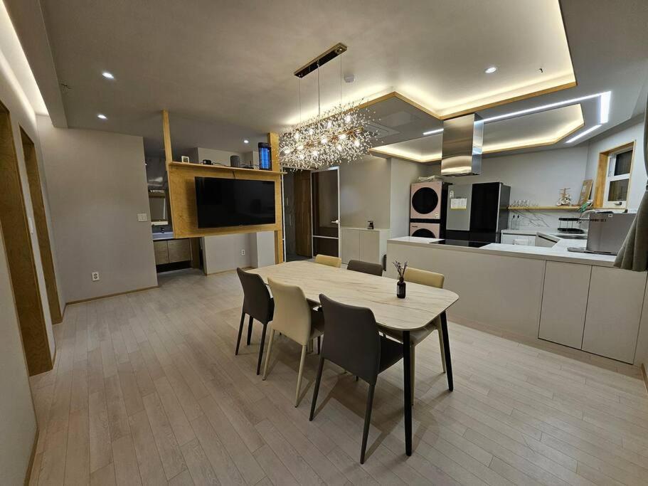 a kitchen and dining room with a table and chairs at IMSTAY friendly child Eoeum Aewol in Jeju