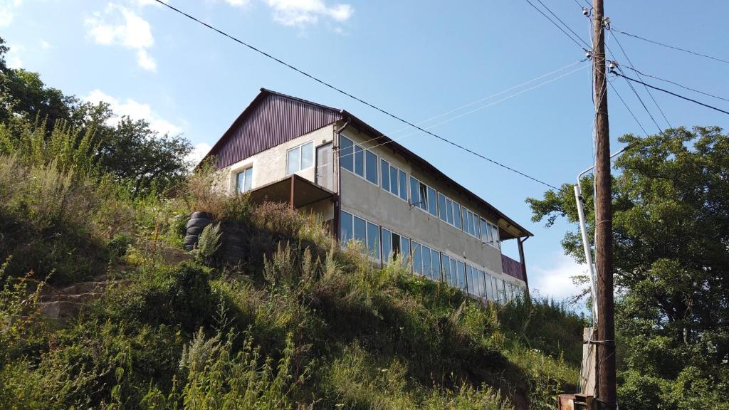 a building on the side of a hill at The Kalavan Retreat Center in Chambarak