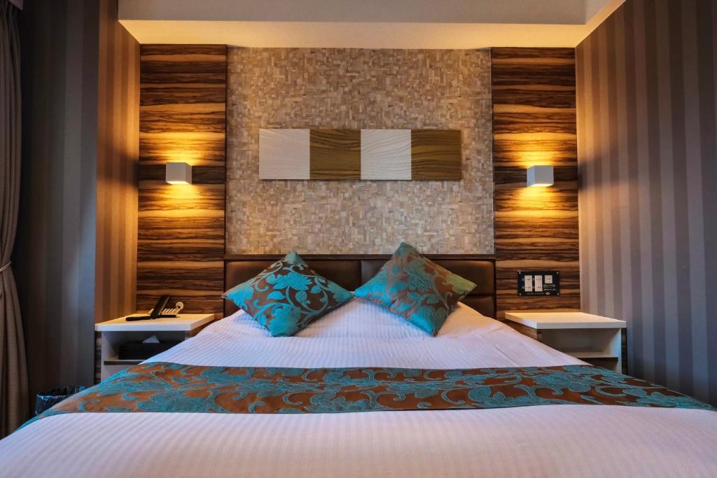 מיטה או מיטות בחדר ב-Amand Hotel