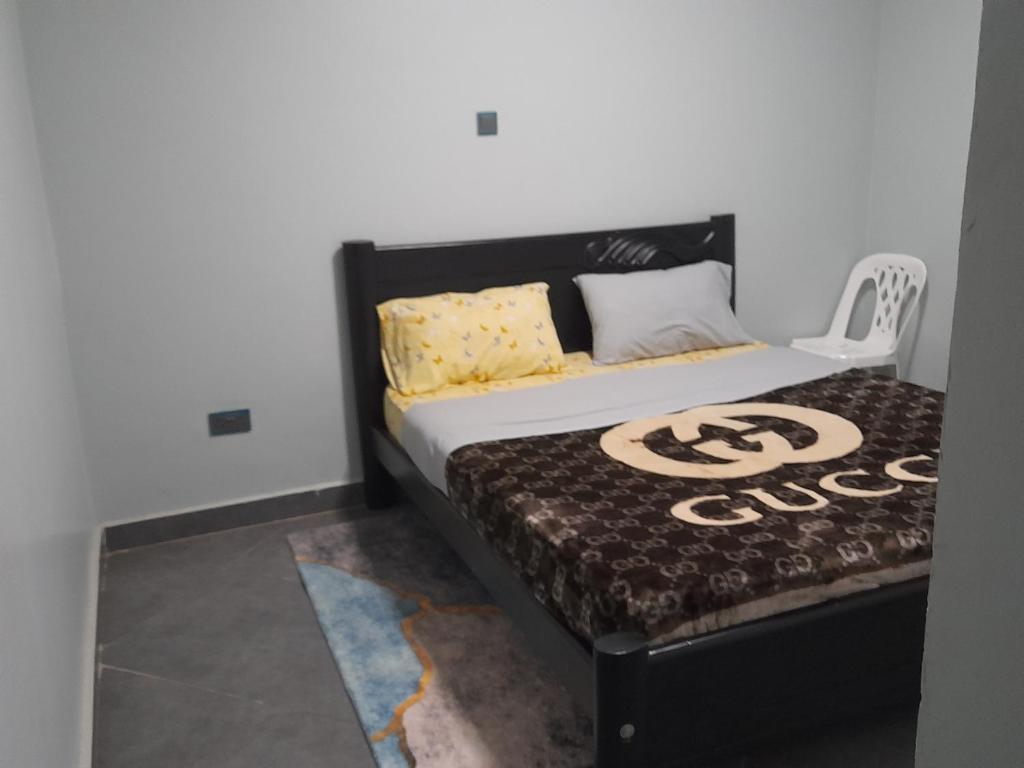 a bed in a room with a black and white mattress at Ella Apartment Albert Cook Road in Kampala