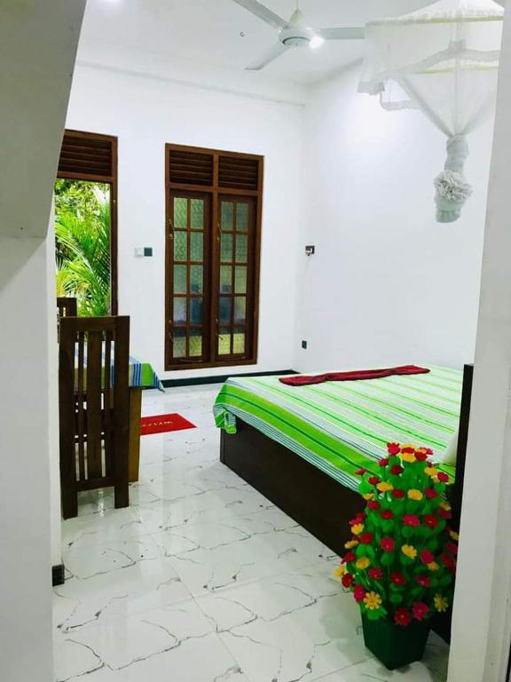 Postel nebo postele na pokoji v ubytování Green jade Inn Mirissa