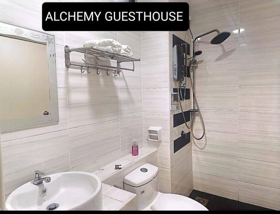 a bathroom with a white toilet and a sink at Alchemy Guesthouse D'summit Residence with Netflix in Johor Bahru