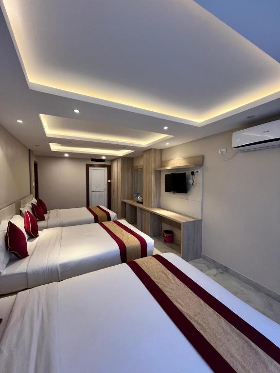 Postel nebo postele na pokoji v ubytování Hotel Prime Suite