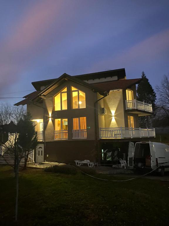 a large house with a van parked in front of it at VILLA M Rustic & Spa in Slatina Varoš