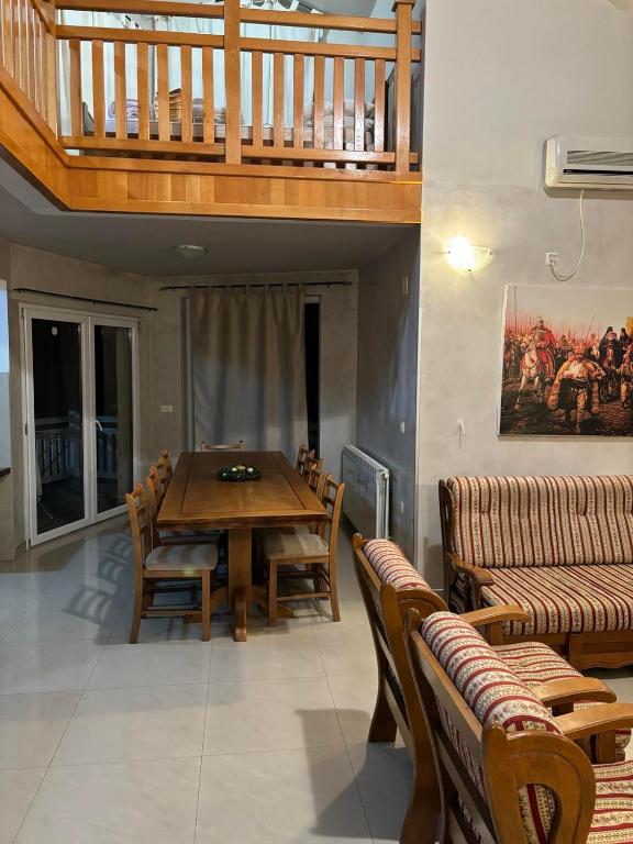 a dining room with a wooden table and chairs at VILLA M Slatina Banja Luka 