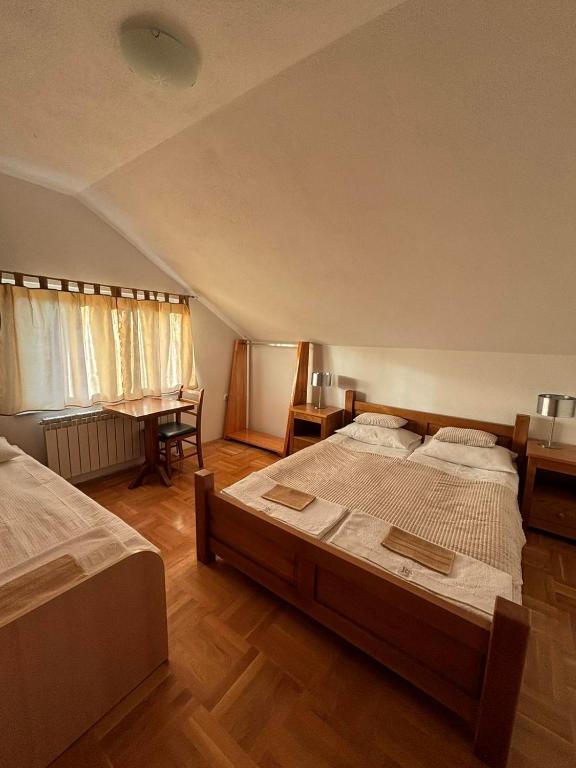 a large bedroom with two beds and a desk at VILLA M Slatina Banja Luka 