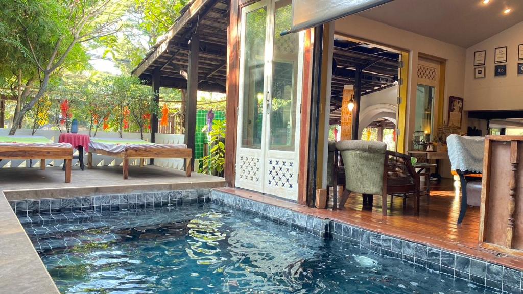 a swimming pool in the middle of a house at Bee Friend Boutique Guesthouse in Chiang Mai