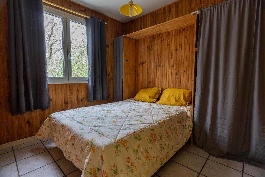 a bedroom with a bed and a window at Domaine de bois joli in Buis-les-Baronnies