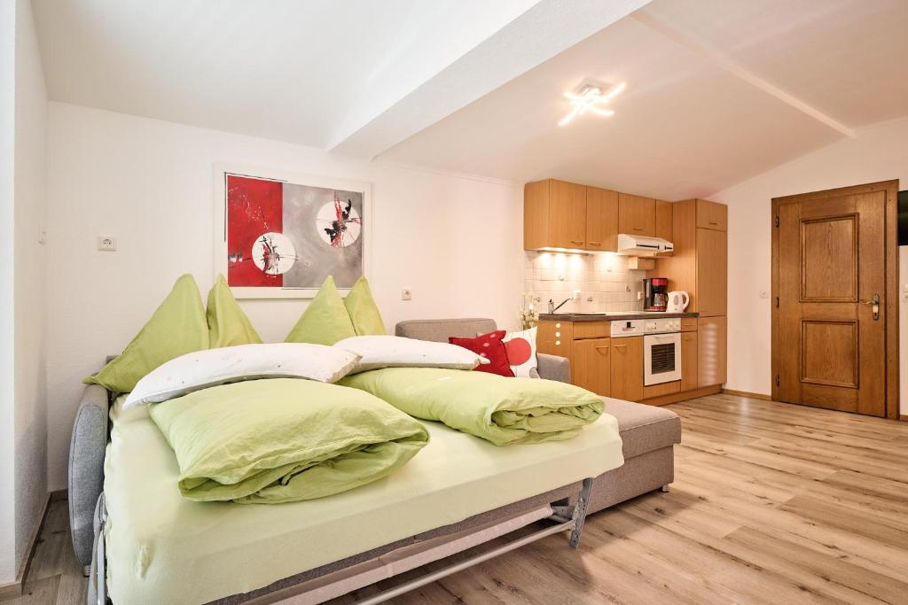 a bedroom with a bed with green pillows at Ferienwohnung Familie Wieser in Altenmarkt im Pongau