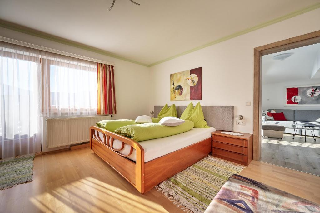 a bedroom with a bed with green pillows at Ferienwohnung Familie Wieser in Altenmarkt im Pongau