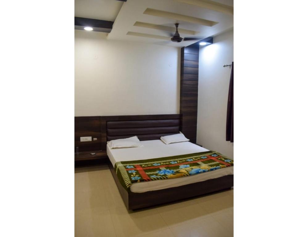 a bedroom with a bed in a room at Hotel City Inn, Gaya in Gaya