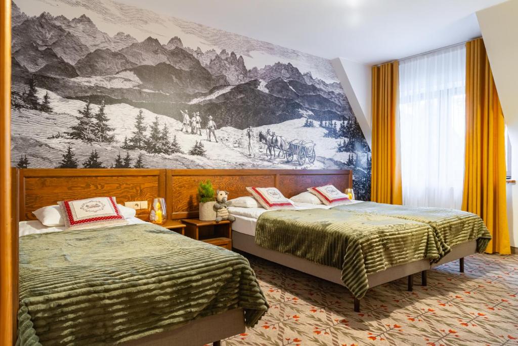 a bedroom with two beds and a mural at Pensjonat Maria 5 in Zakopane