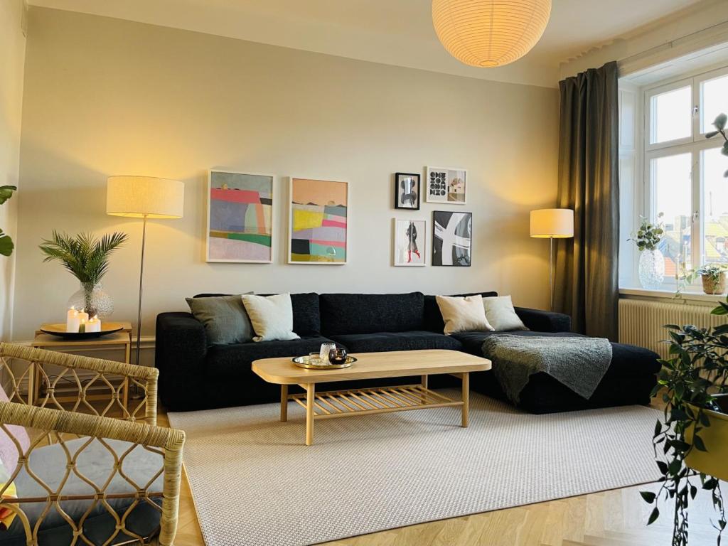 a living room with a couch and a coffee table at Trendy and light 2 room apartment in SoFo, 65sqm in Stockholm