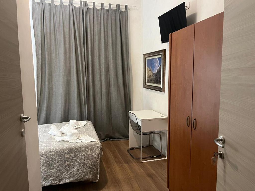 a small room with a bed and a desk at Les Artes in Rome