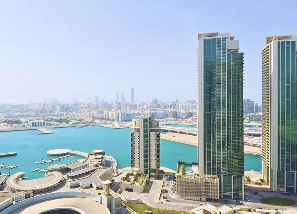 an aerial view of a city with tall buildings at Sea View Cozy 2BHK Al Reem 6ppl - more than 10 days stay free transportation from Abu Dhabi Airport- in Abu Dhabi