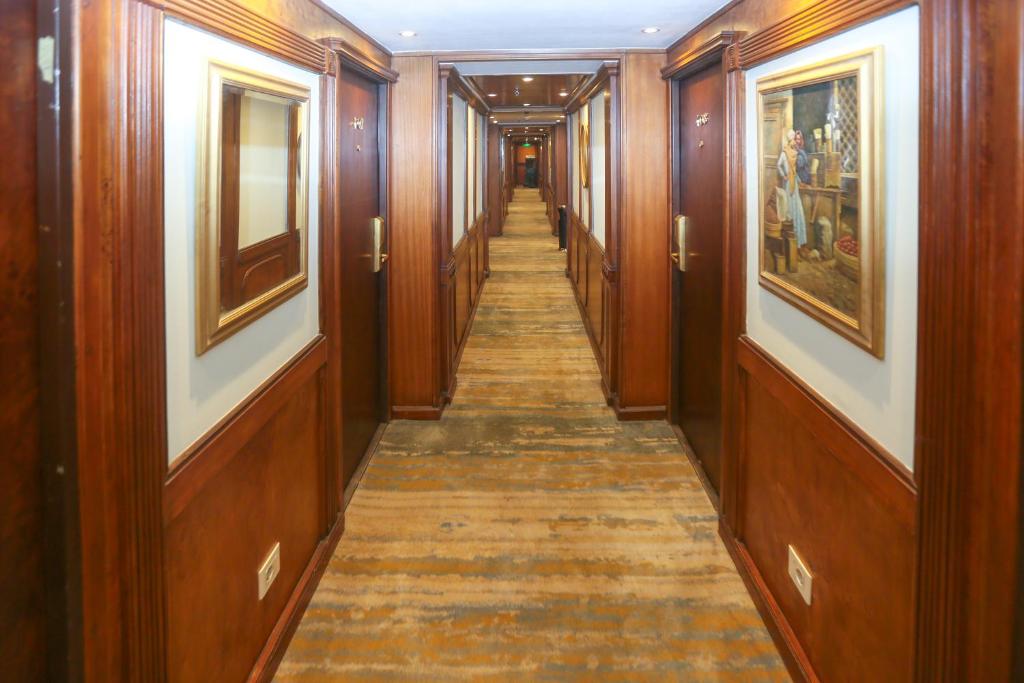 a hallway with wood paneling and a long aisle at Orient MS Grand Rose in Luxor
