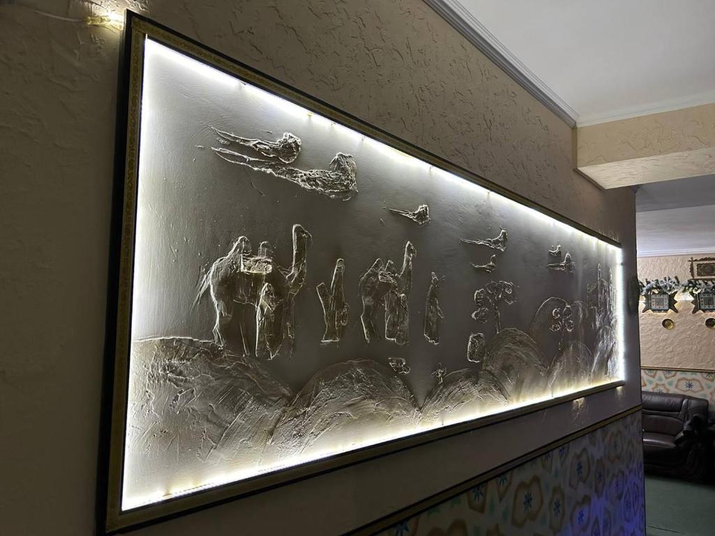 a picture of a fishtank on a wall at 7 Pir in Bukhara
